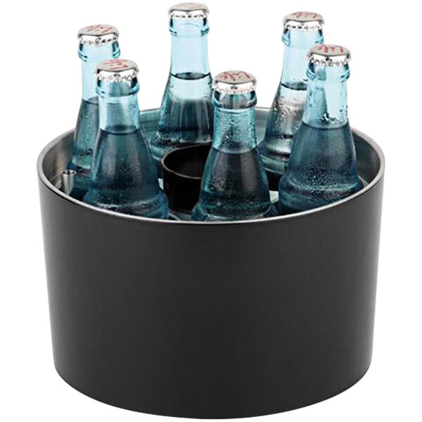 A black metal APS bottle cooler filled with blue glass soda bottles.