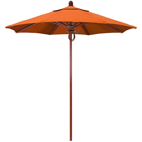 A California Umbrella orange outdoor umbrella with a wooden pole.