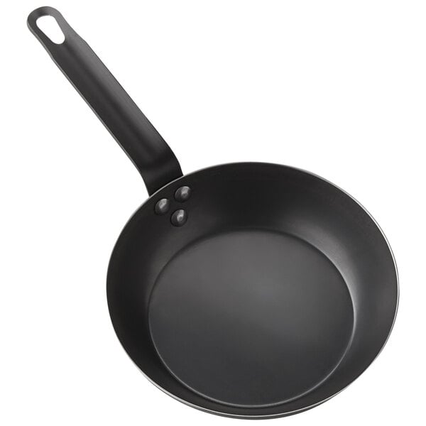 An American Metalcraft black carbon steel fry pan with a handle.