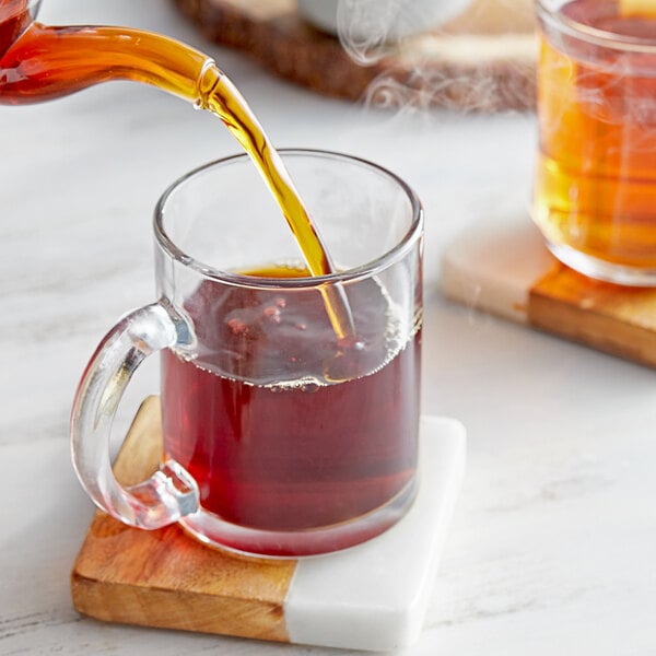 A glass mug filled with Davidson's Organic Russian Caravan loose leaf tea.