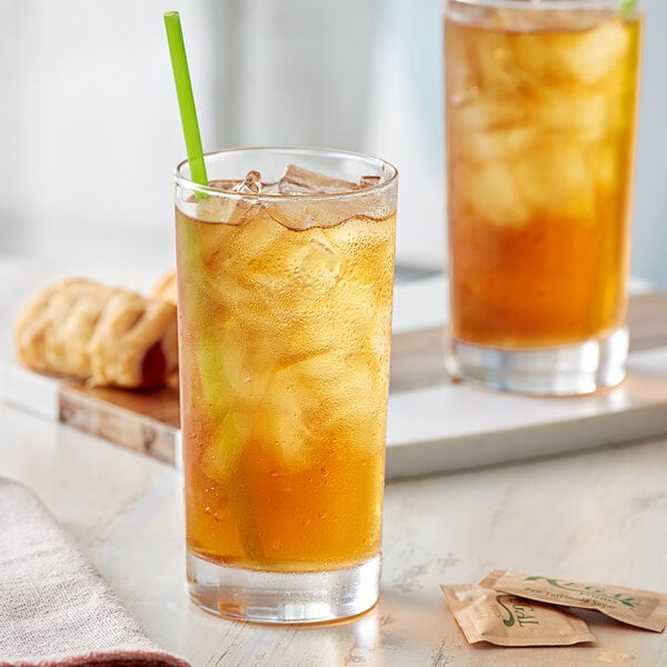 A glass of Davidson's Organic Decaf Ceylon Black Iced Tea with a green straw.