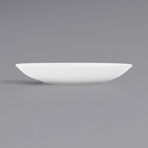 A Corona by GET Enterprises bright white porcelain plate on a gray surface.