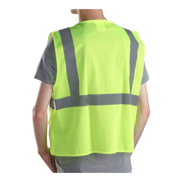 A person wearing a lime green Cordova high visibility safety vest.