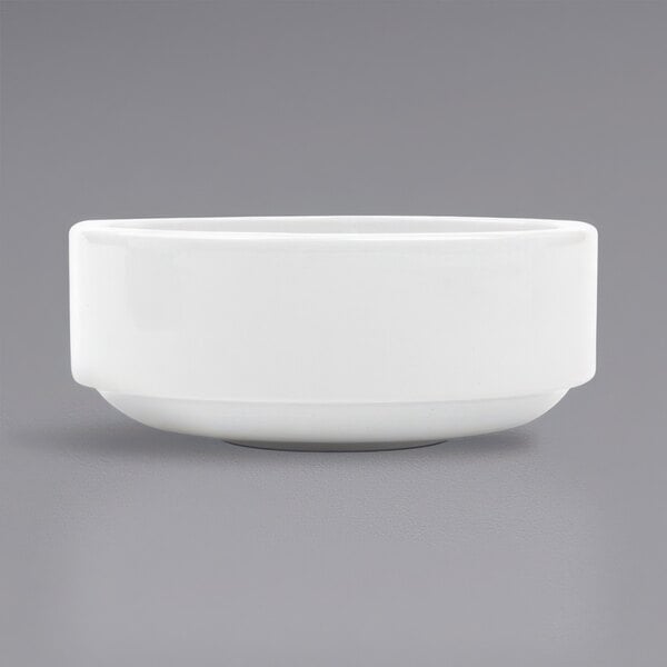 A stackable bright white porcelain bouillon bowl on a gray background.