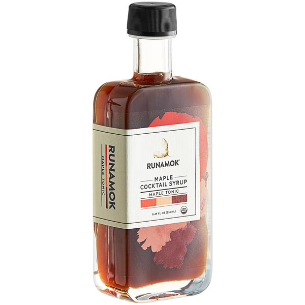 A bottle of Runamok Maple Tonic cocktail syrup with a white label.