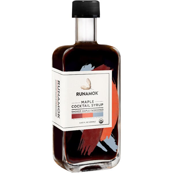 A bottle of Runamok Smoked Maple Old Fashioned cocktail syrup with a white label.
