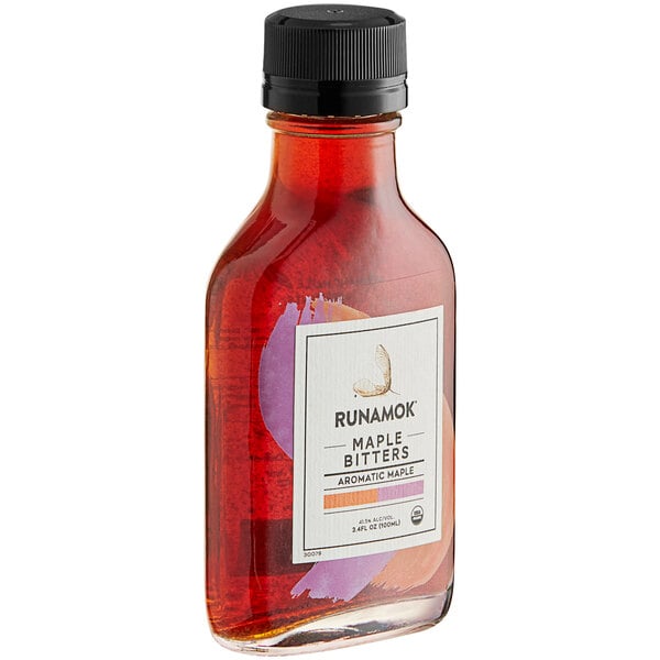 A close up of a bottle of Runamok Aromatic Maple Bitters with a black cap.