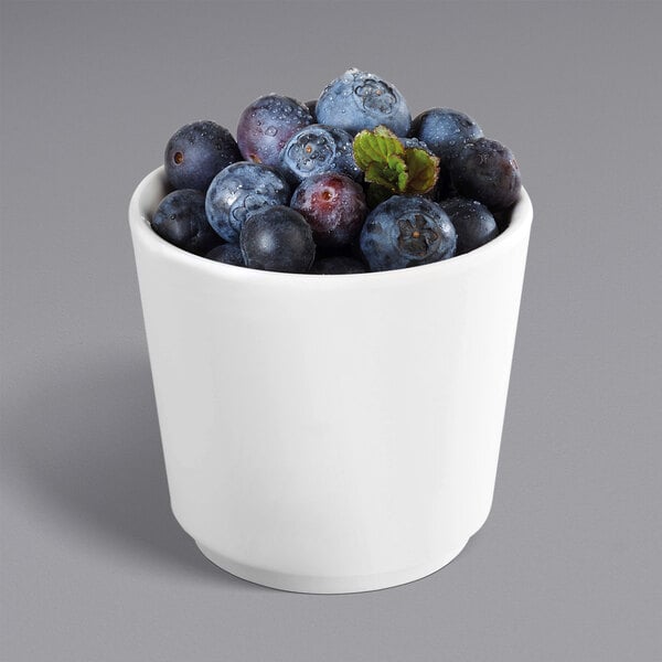 A white APS melamine bowl filled with blueberries.