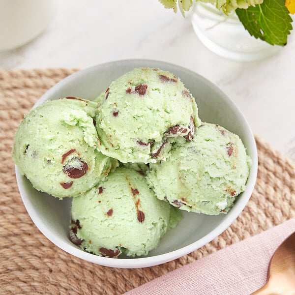 A bowl of Cookie Dough Bliss mint chip cookie dough on a white background.