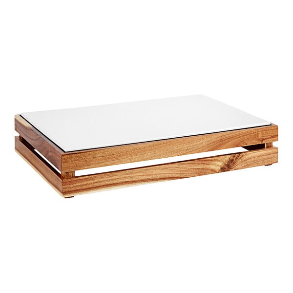 A wooden rectangular crate with a white surface on a table.