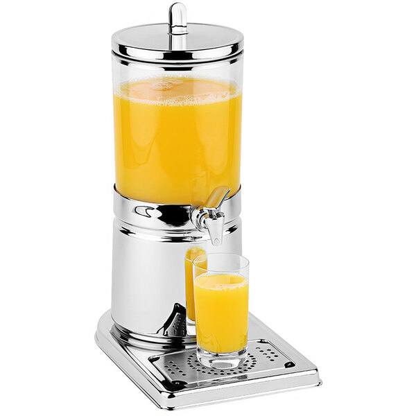 A stainless steel beverage dispenser with a glass of orange juice on the side.