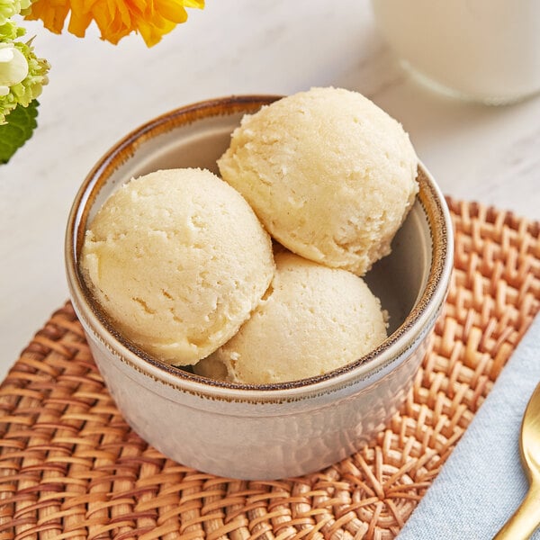 A bowl of Cookie Dough Bliss salted caramel cookie dough on a table.