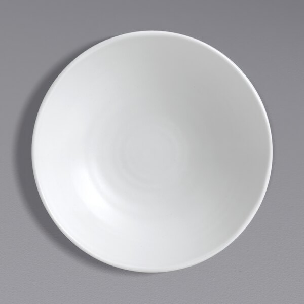 A Dudson Organic White china plate on a gray surface.