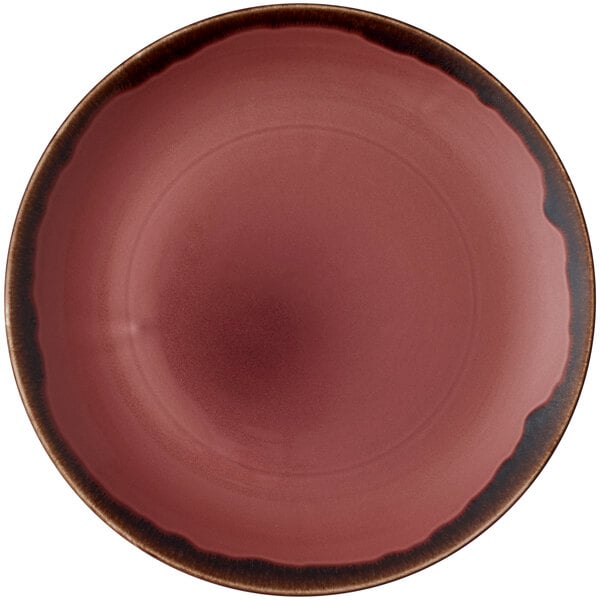 A plum china plate with a brown rim.