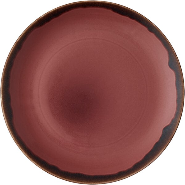 A red plate with a black rim and a pink circle in the center.