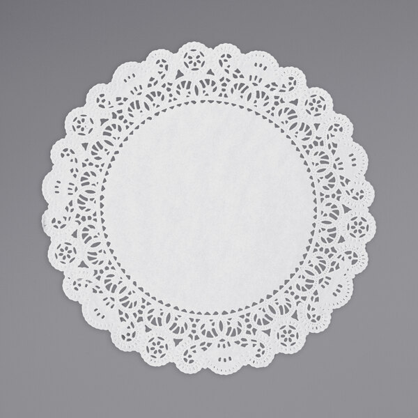 A white Lace Normandy doily on a gray surface.