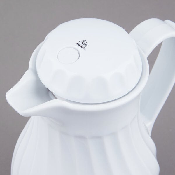 A white ceramic Vollrath SwirlServe coffee server with a handle and lid.