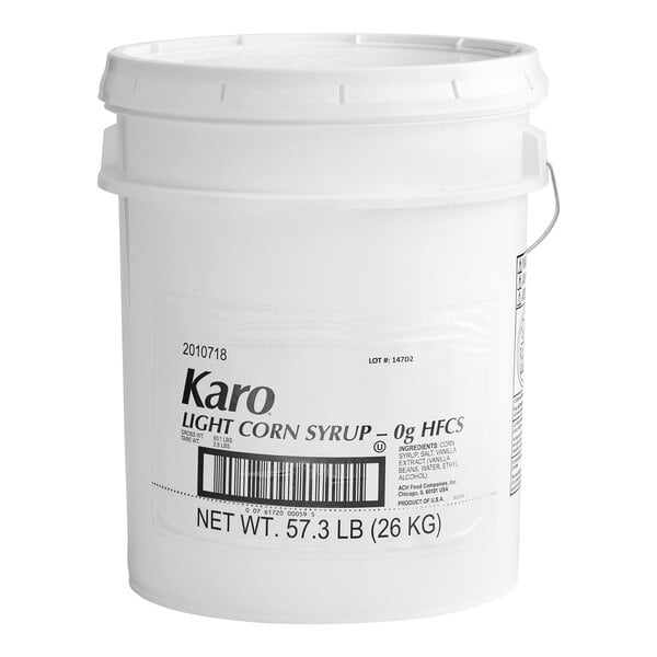 A large white plastic bucket labeled 'Karo Light Corn Syrup' with a net weight of 57.3 lb (26 kg).
