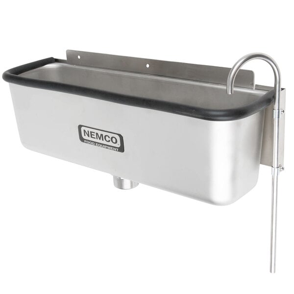 A stainless steel Nemco ice cream dipper well and faucet set on a counter.