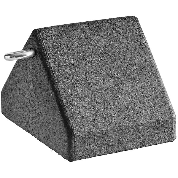 A black rubber wheel chock with eyebolt on a table.