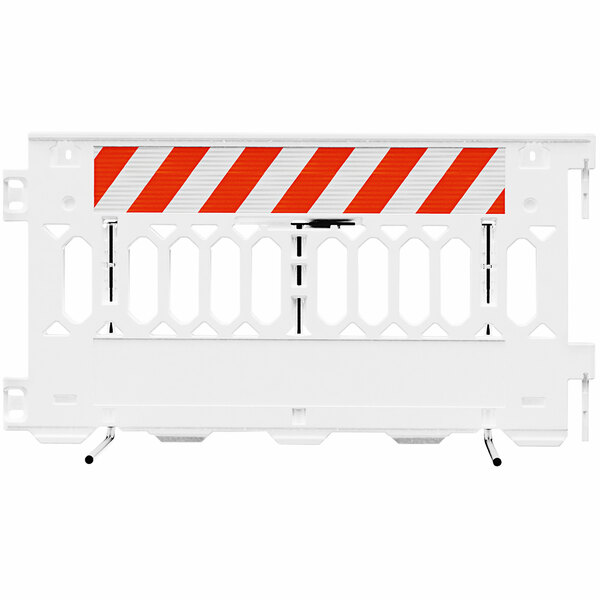 A white Plasticade parade barricade with white and orange striped sheeting on one side.