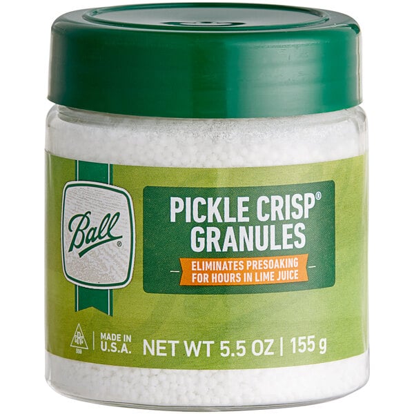 A jar of Ball Pickle Crisp Granules with a green lid.