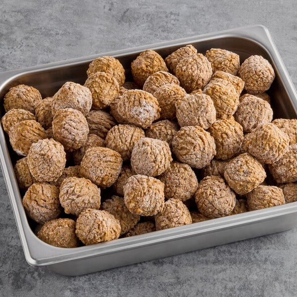 A metal tray with brown Gardein plant-based meatballs on it.