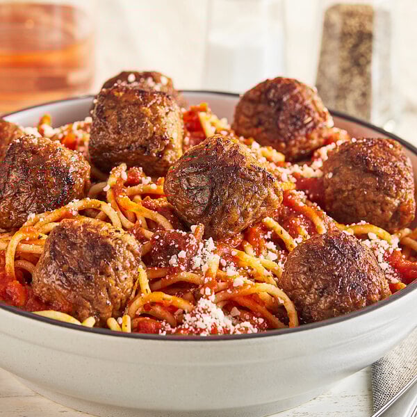 A bowl of spaghetti and Gardein plant-based vegan meatballs with sauce.