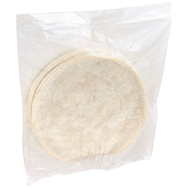 A white plastic bag containing a stack of Udi's Gluten-Free pizza crusts.