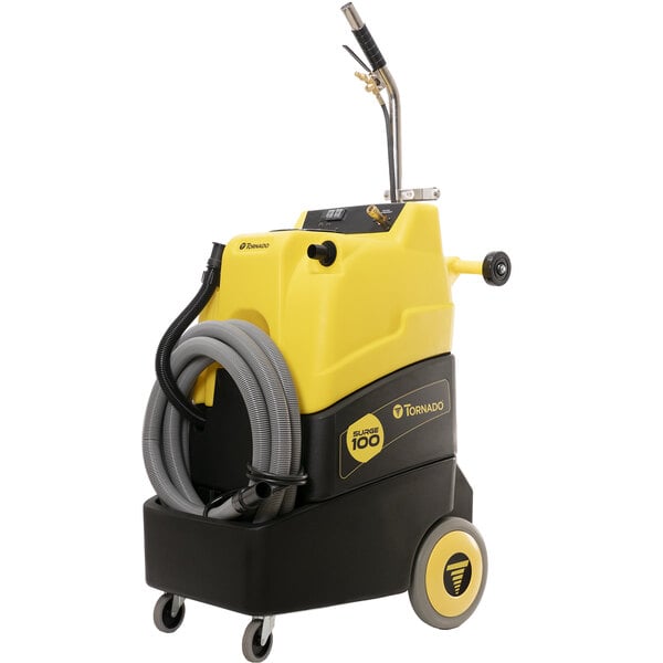 A yellow and black Tornado Surge 220 carpet extractor with hoses.