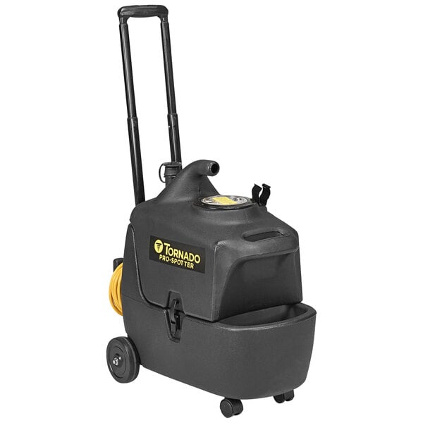A black Tornado Pro Spotter corded extractor with yellow label and wheels.