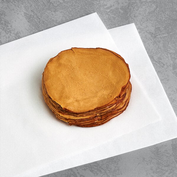 A stack of Tofurky vegan deli slices on a white surface.