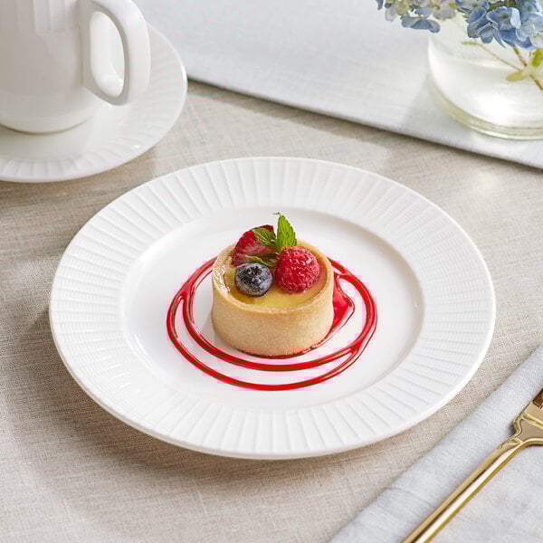 An Acopa Cordelia white porcelain plate with a dessert and berries on it.