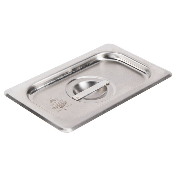 A Vollrath stainless steel hotel pan cover on a metal tray.
