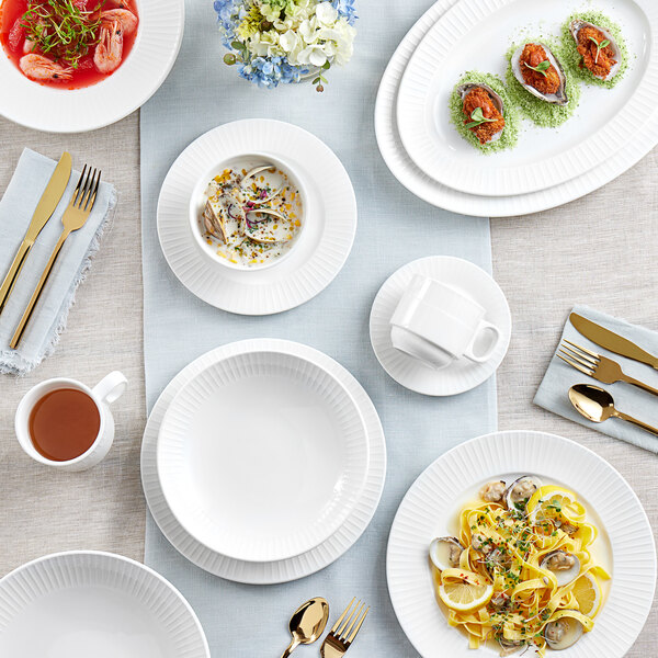 A table set with Acopa Cordelia dinnerware including plates, bowls, and cups.