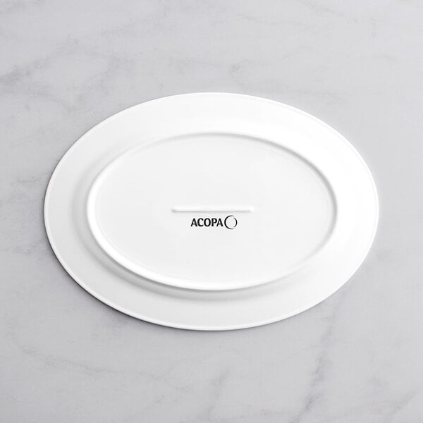 A white Acopa Cordelia porcelain platter with an embossed design.