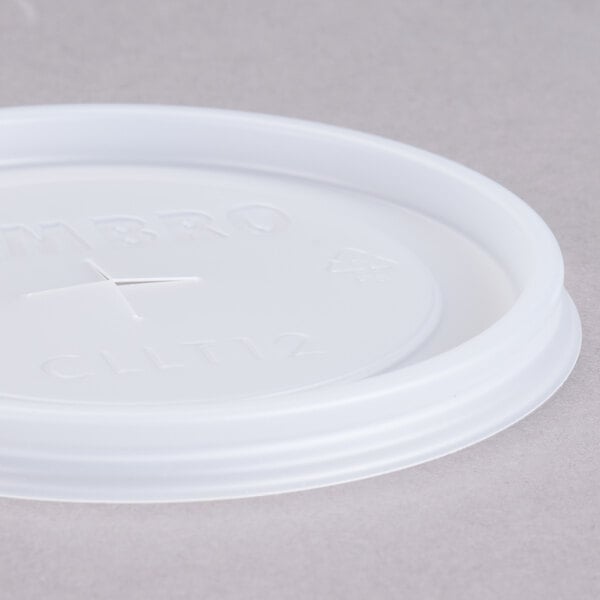 A white plastic lid with a straw slot.
