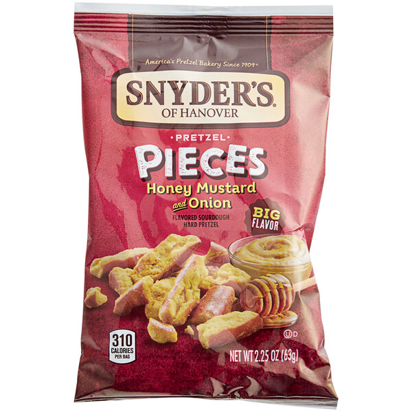 A bag of Snyder's Honey Mustard Pretzel Pieces on a table.