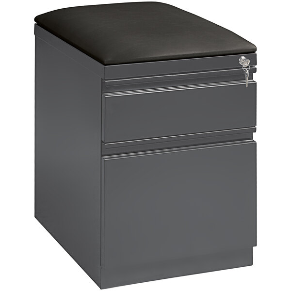 A Hirsh Industries charcoal filing cabinet with black seat cushion on top.