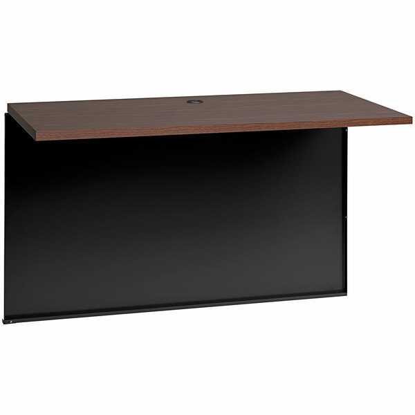 A black and brown Hirsh Industries bridge for a modular desk.