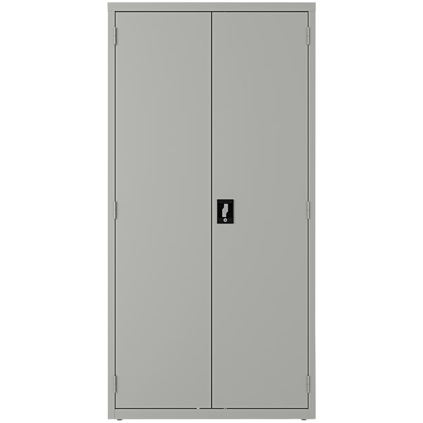 A light gray steel storage cabinet with black handles and doors by Hirsh Industries.