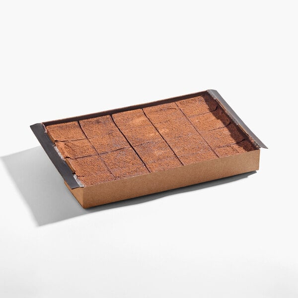 A rectangular pre-cut vegan Belgian chocolate cheesecake in a cardboard tray, divided into 20 slices.