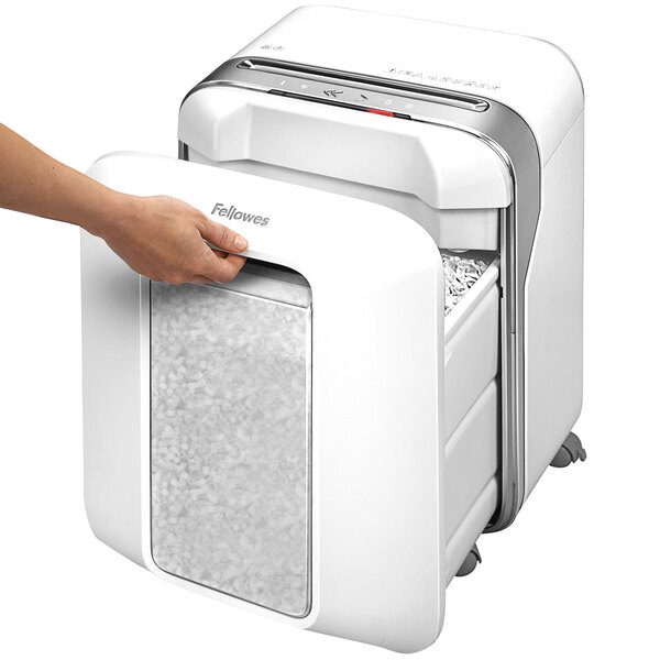 A person's hand using a Fellowes Powershred LX200 white micro-cut shredder.