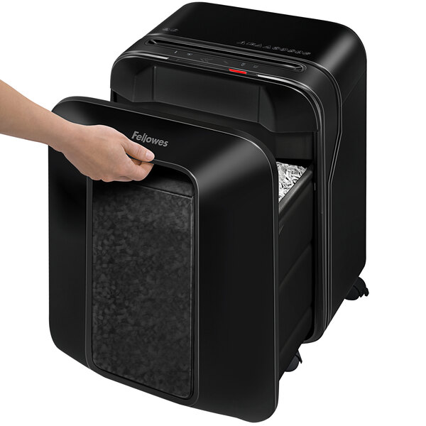 A hand using a Fellowes Powershred LX200 paper shredder.