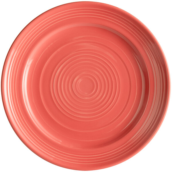 A close-up of a Tuxton Concentrix Cinnebar China plate with spirals on the rim.