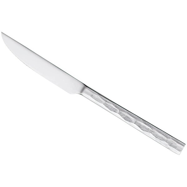 A silver steak knife with a white handle.