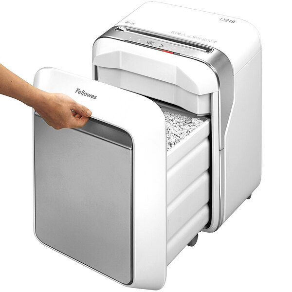 A person's hand opening a Fellowes Powershred LX210 White Micro-Cut Shredder.