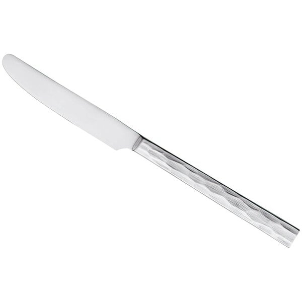 A silver knife with a textured white handle.