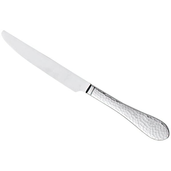 A silver knife with a textured curved handle.