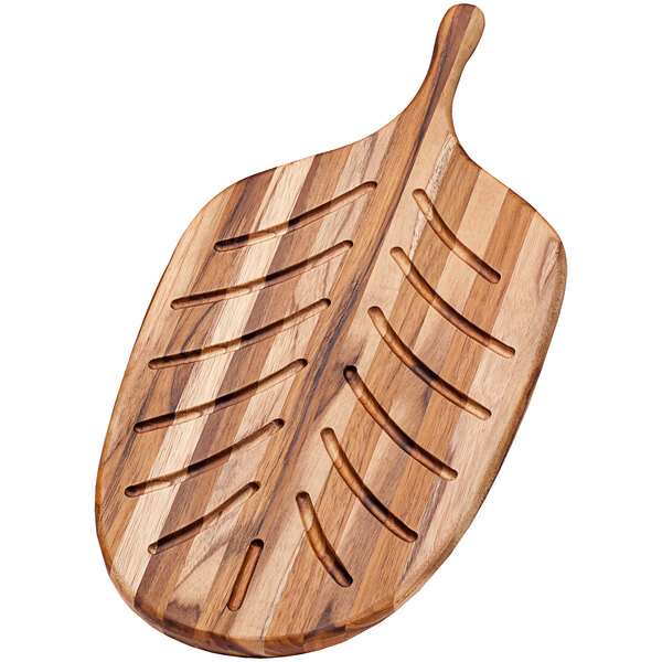 A Teakhaus teakwood paddle serving board with a carved leaf design.